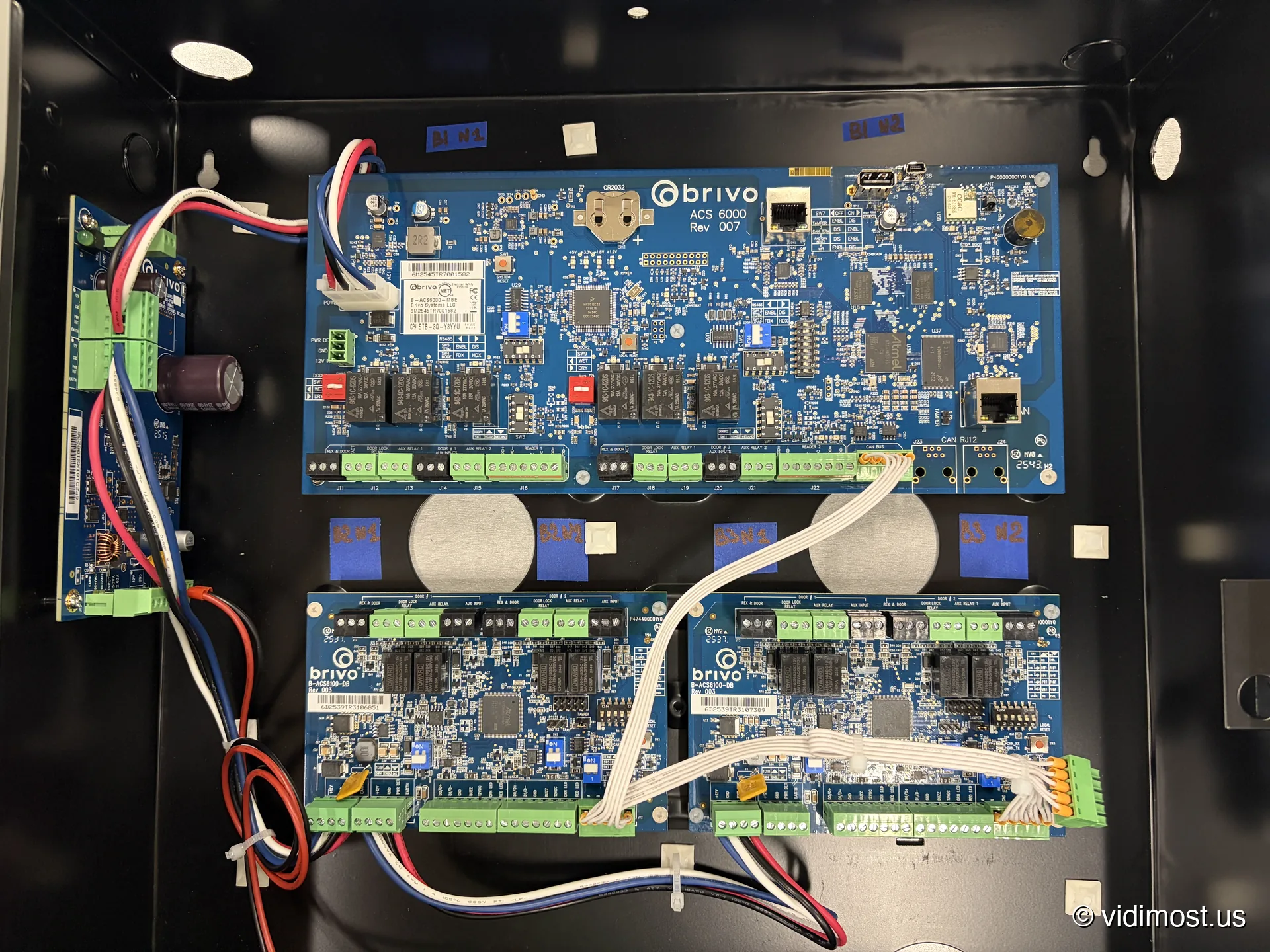 Brivo ACS6000 controller with two ACS6100-DB door boards in a labeled black cabinet, Chicago installation