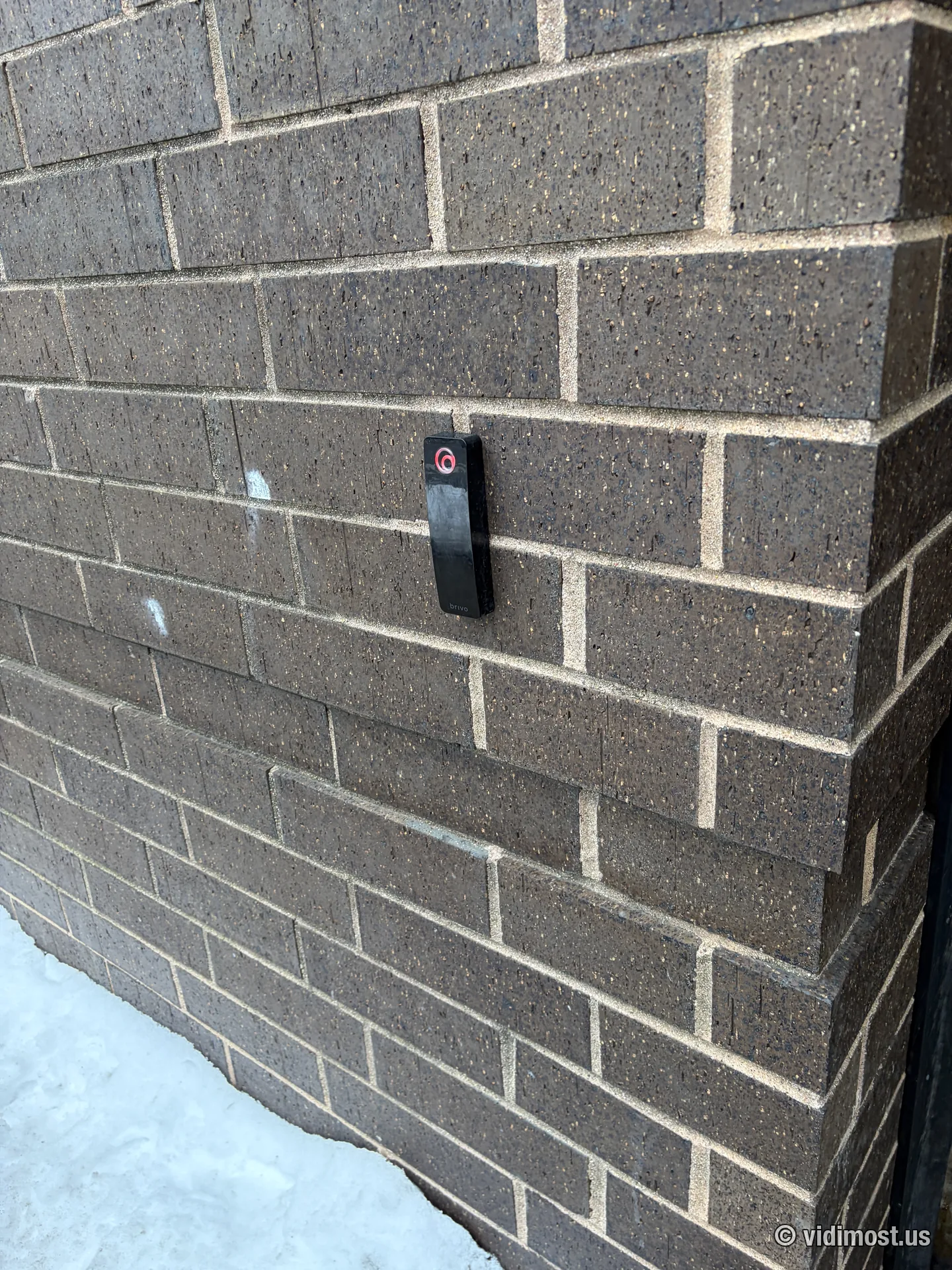 Access control conduit run on a brick Chicago building during winter installation