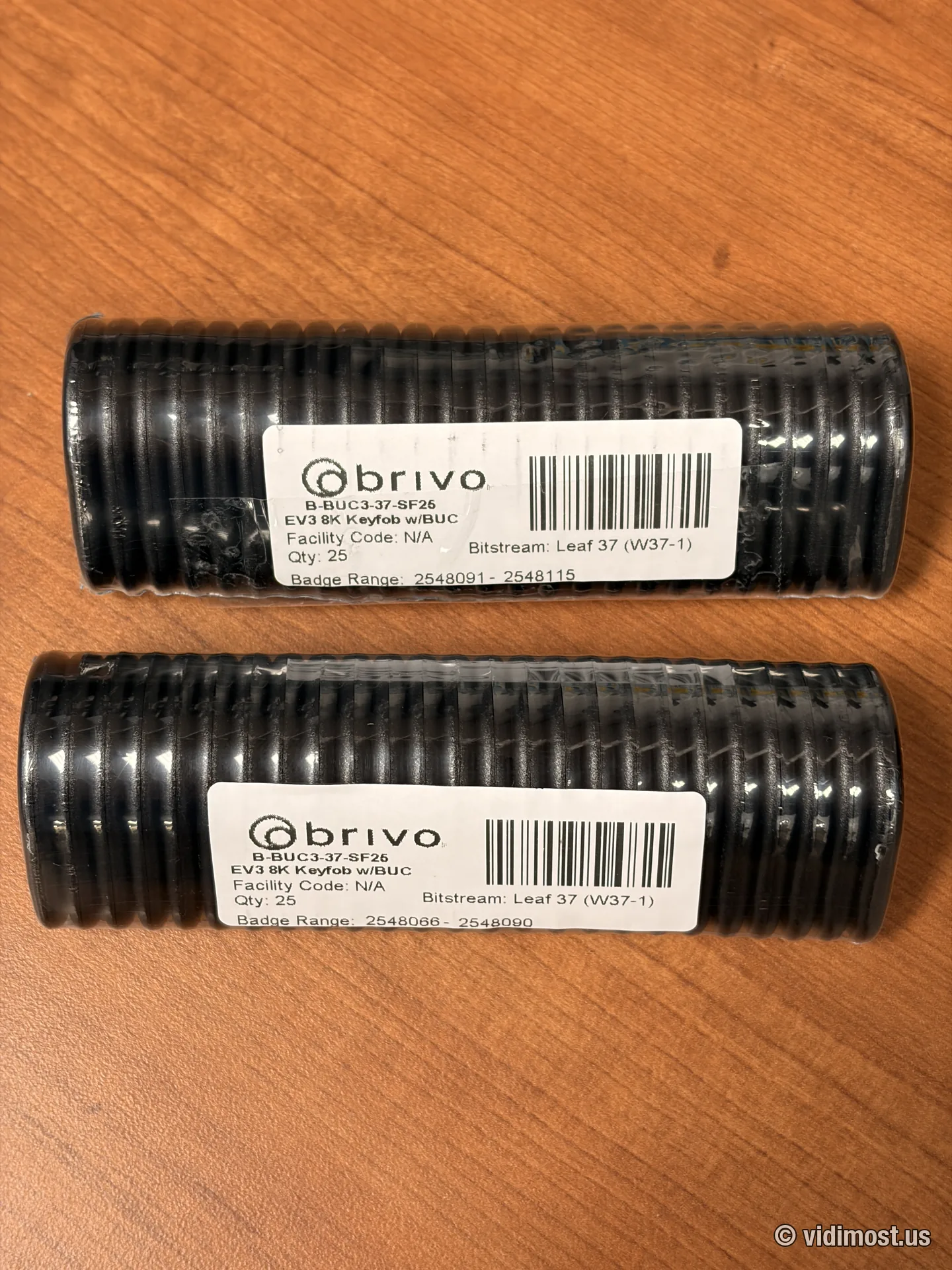 Two factory tubes of Brivo B-BUC3 key fobs with badge-range labels, 25 fobs each