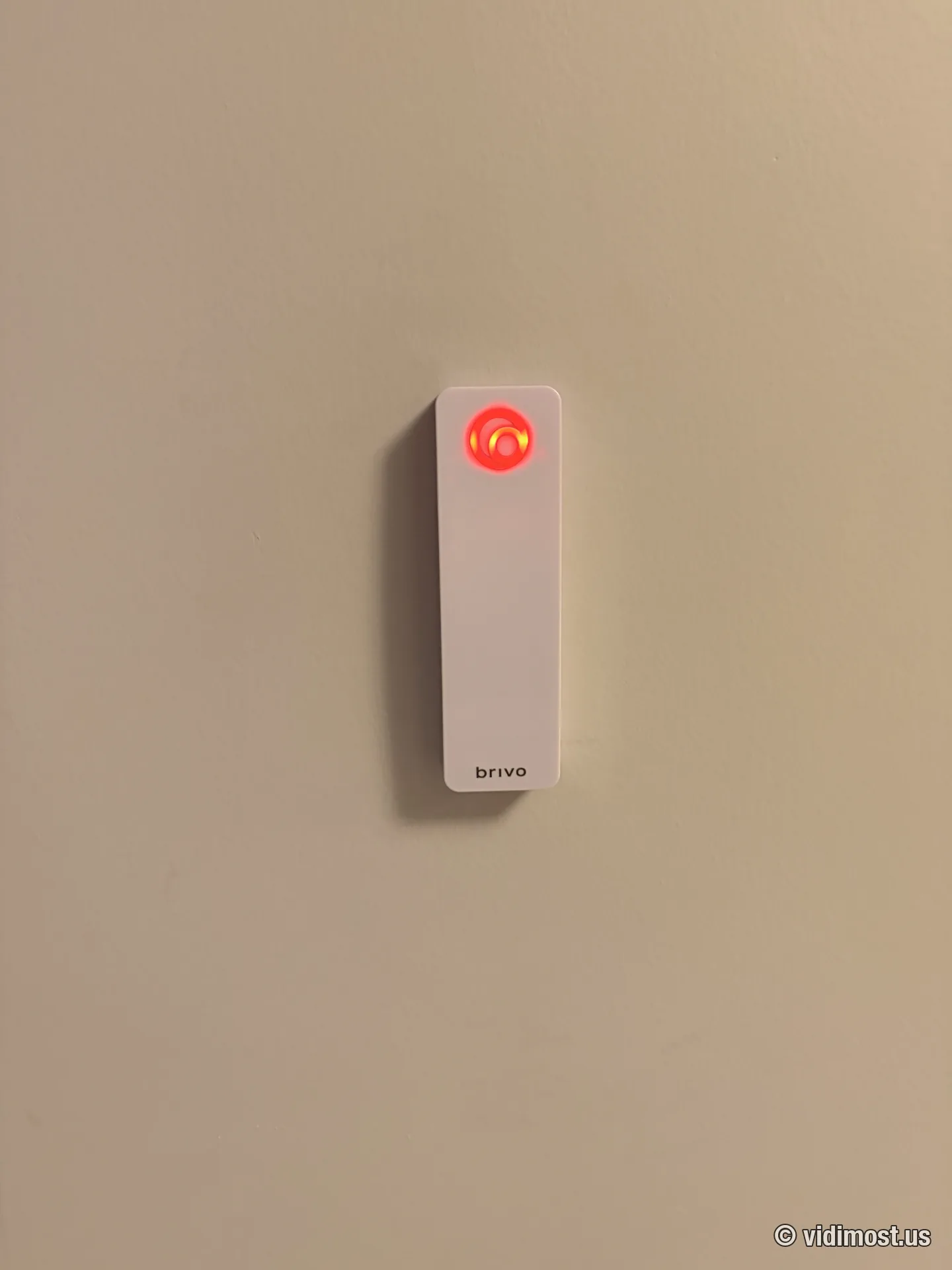White Brivo smart reader with red locked-state LED on an interior office wall